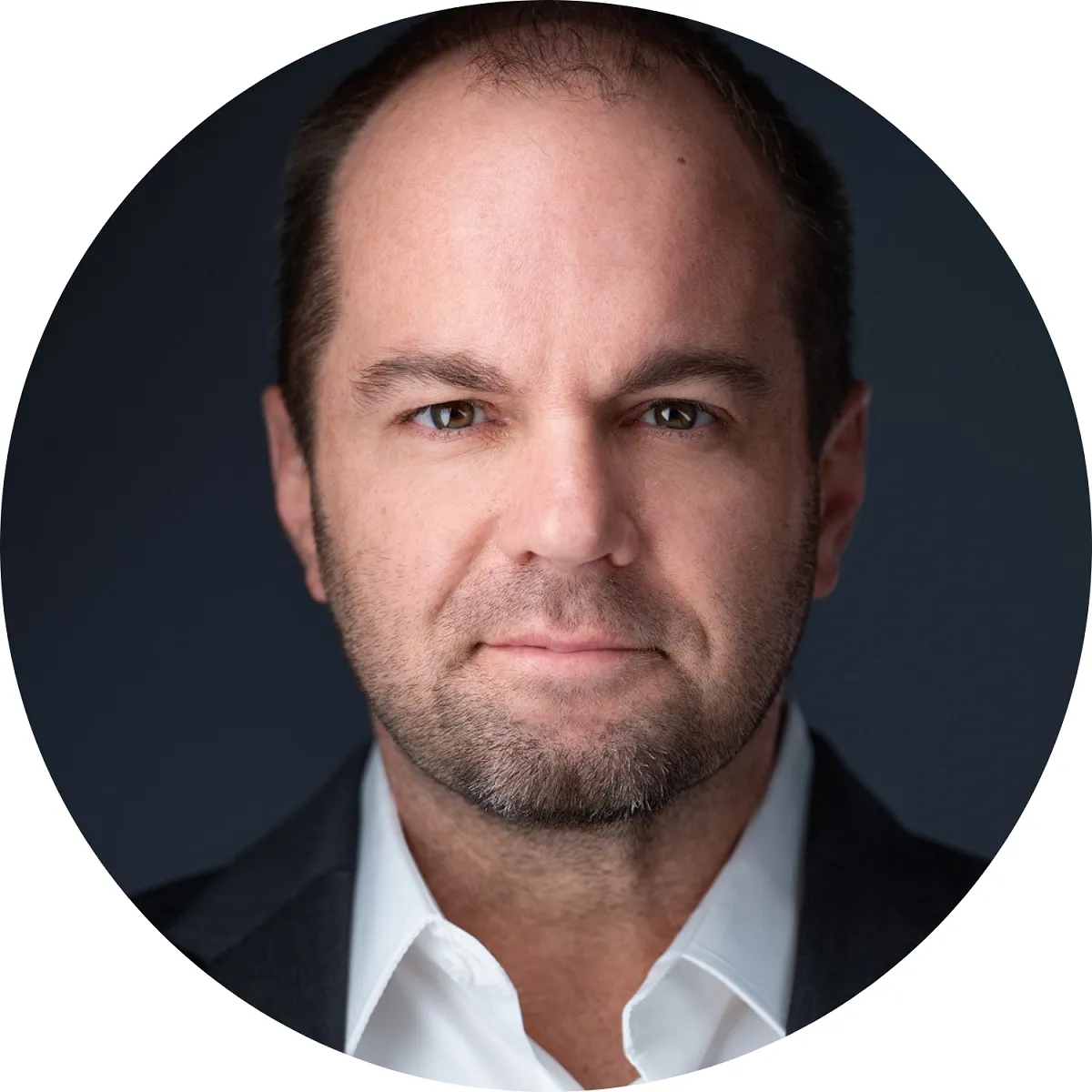 Entrepreneur and strategic advisor Nick Berry's headshot on a dark gray background.