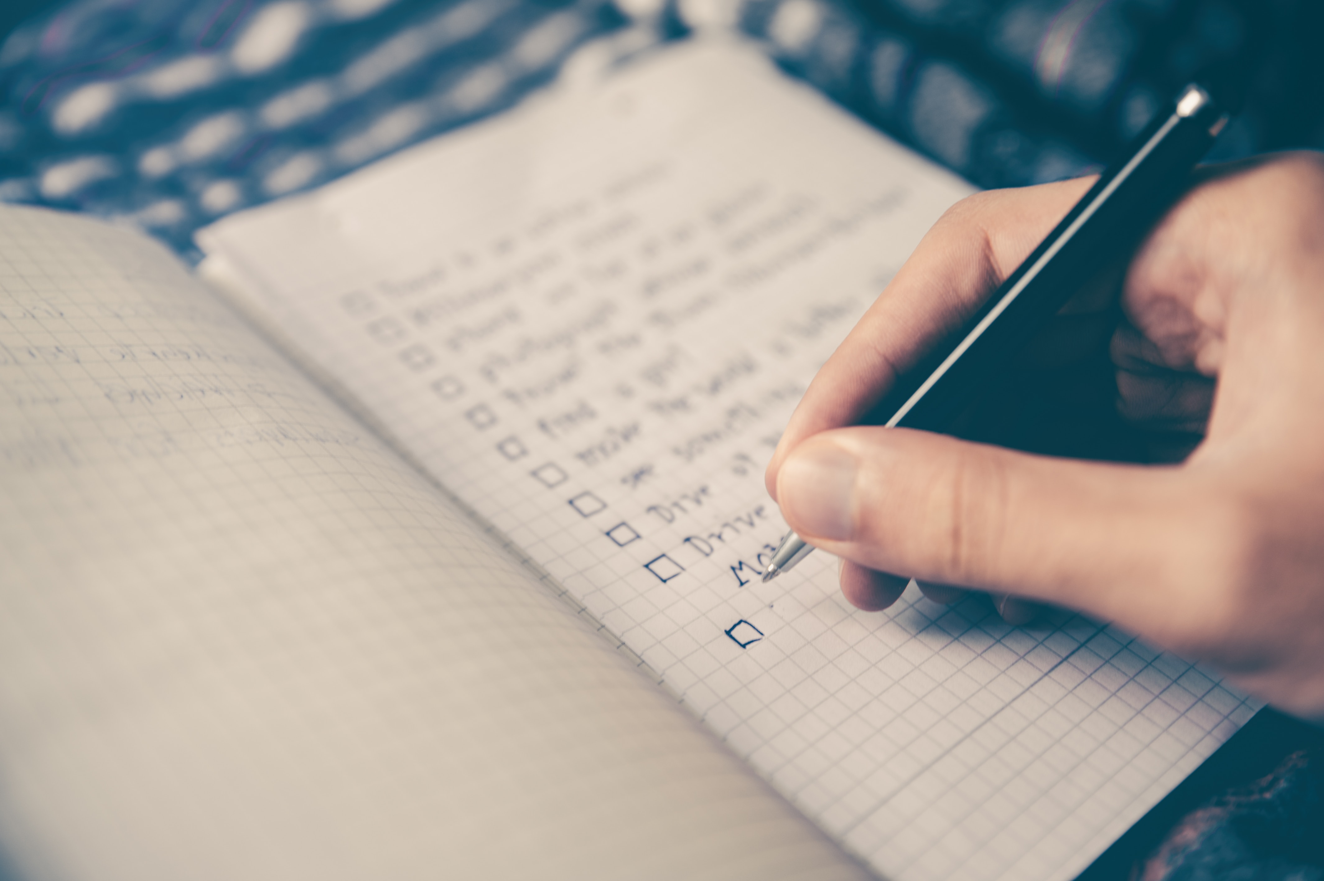 Fitness enthusiast outlining fitness blog post ideas in a notebook.