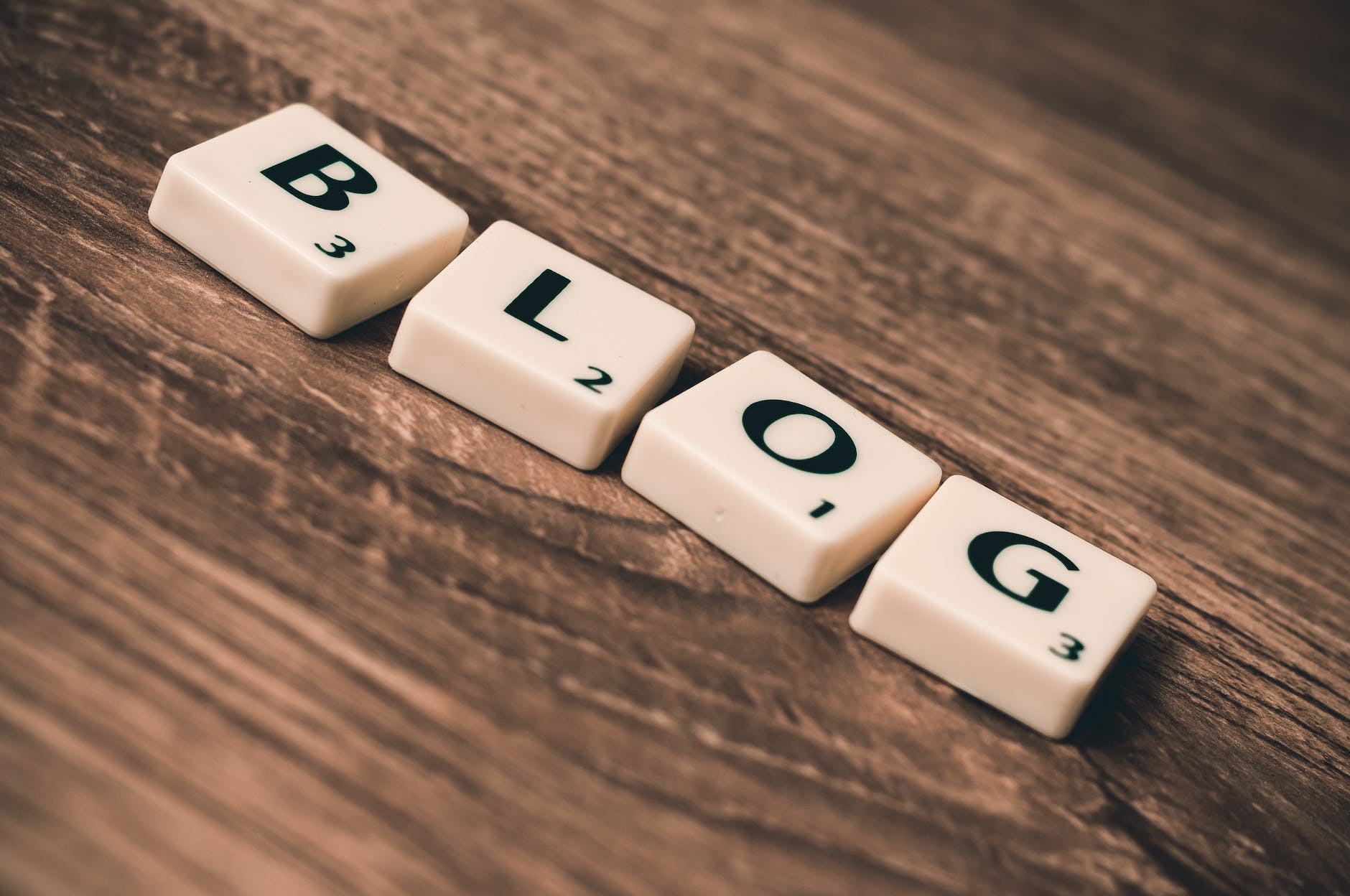 Blog post optimization for gyms, represented by 'blog' spelled out on wooden table.