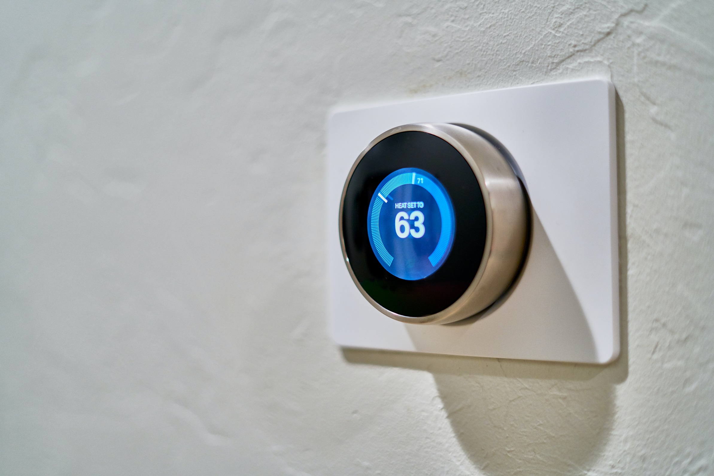 Smart thermostat showcasing local HVAC business SEO strategies on a wall.
