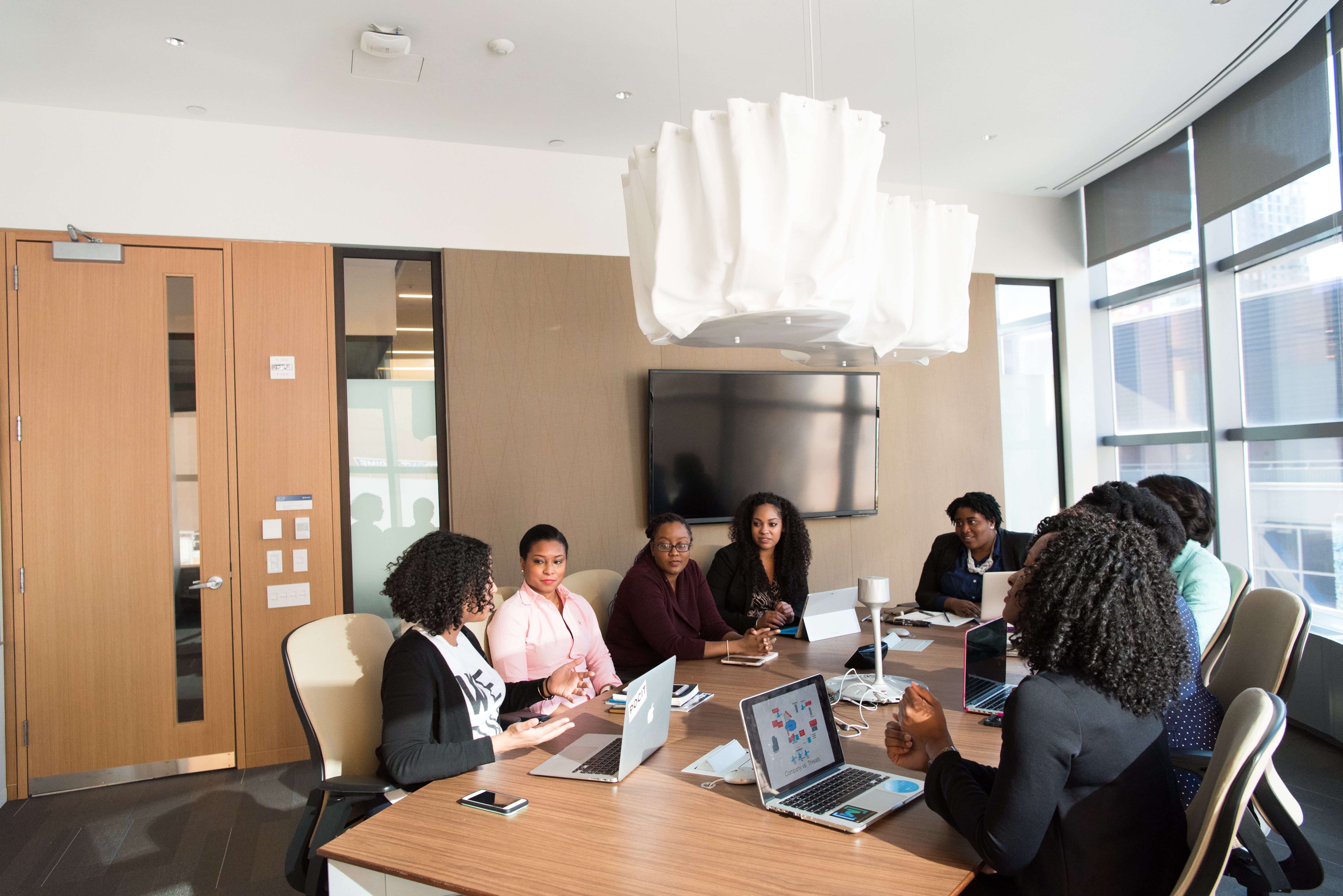 Blog writers for pool service business discussing strategies in a conference room