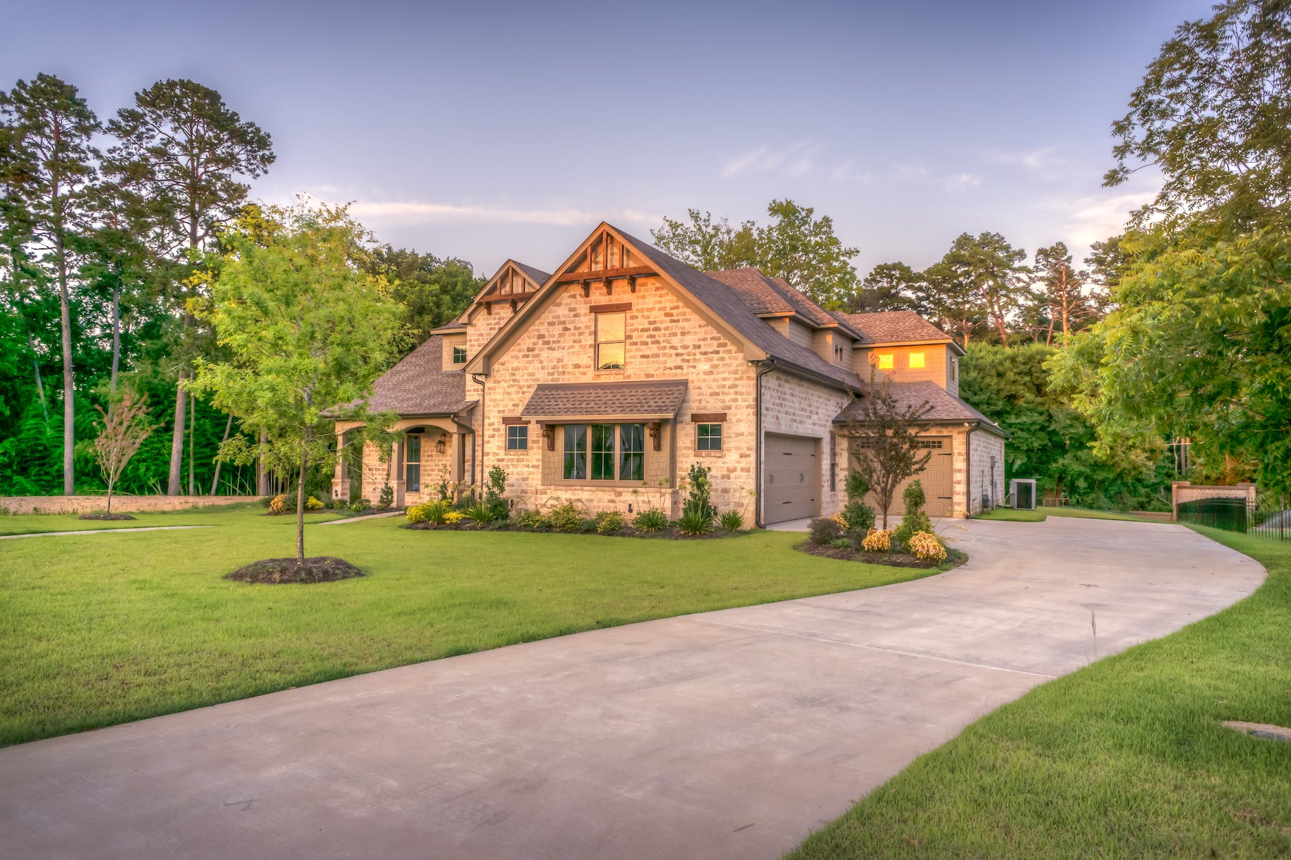 Blog writers for landscaping business planning a tree-lined driveway home design.