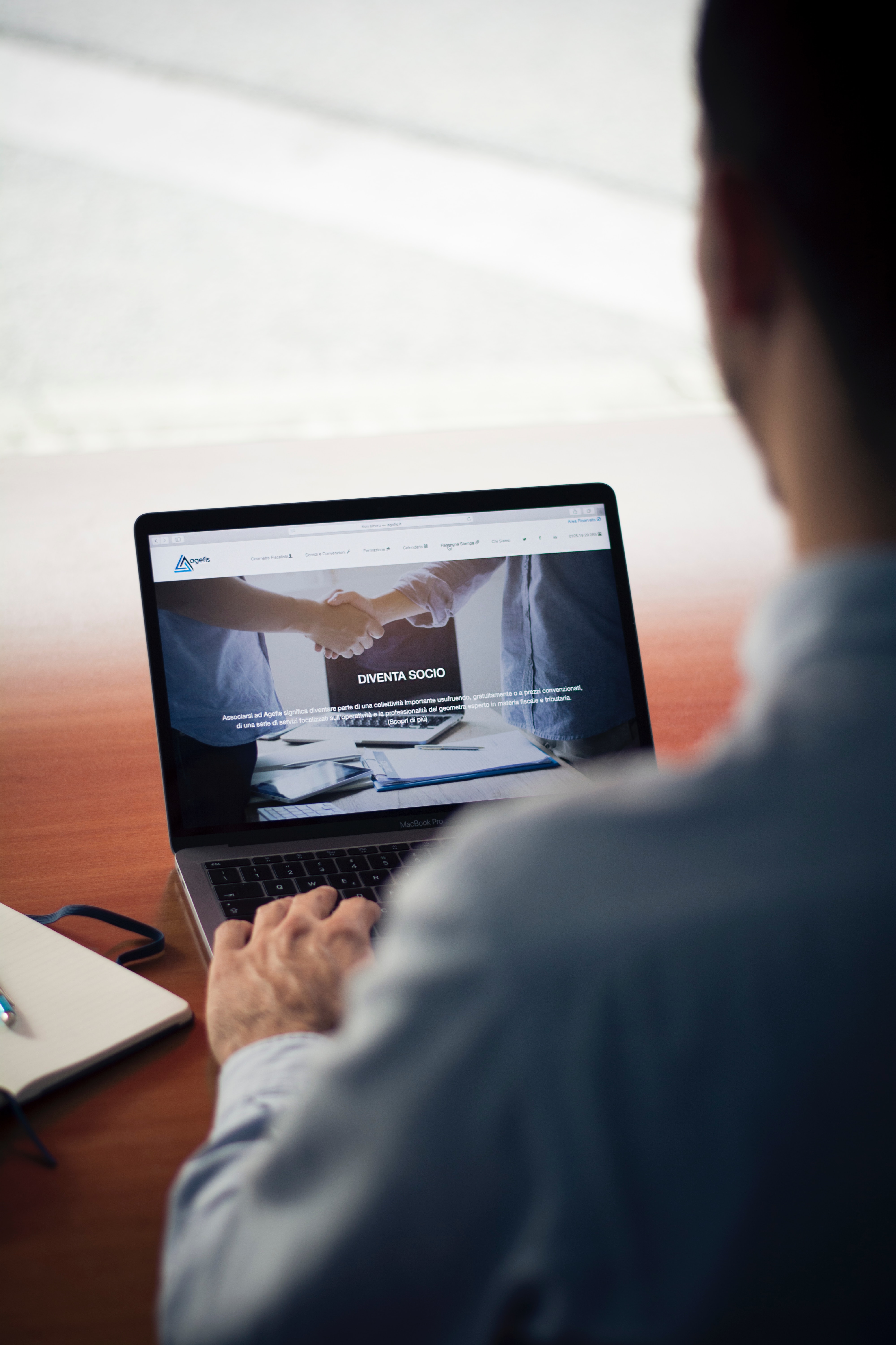 Man optimizing blog post for landscaping business website on laptop