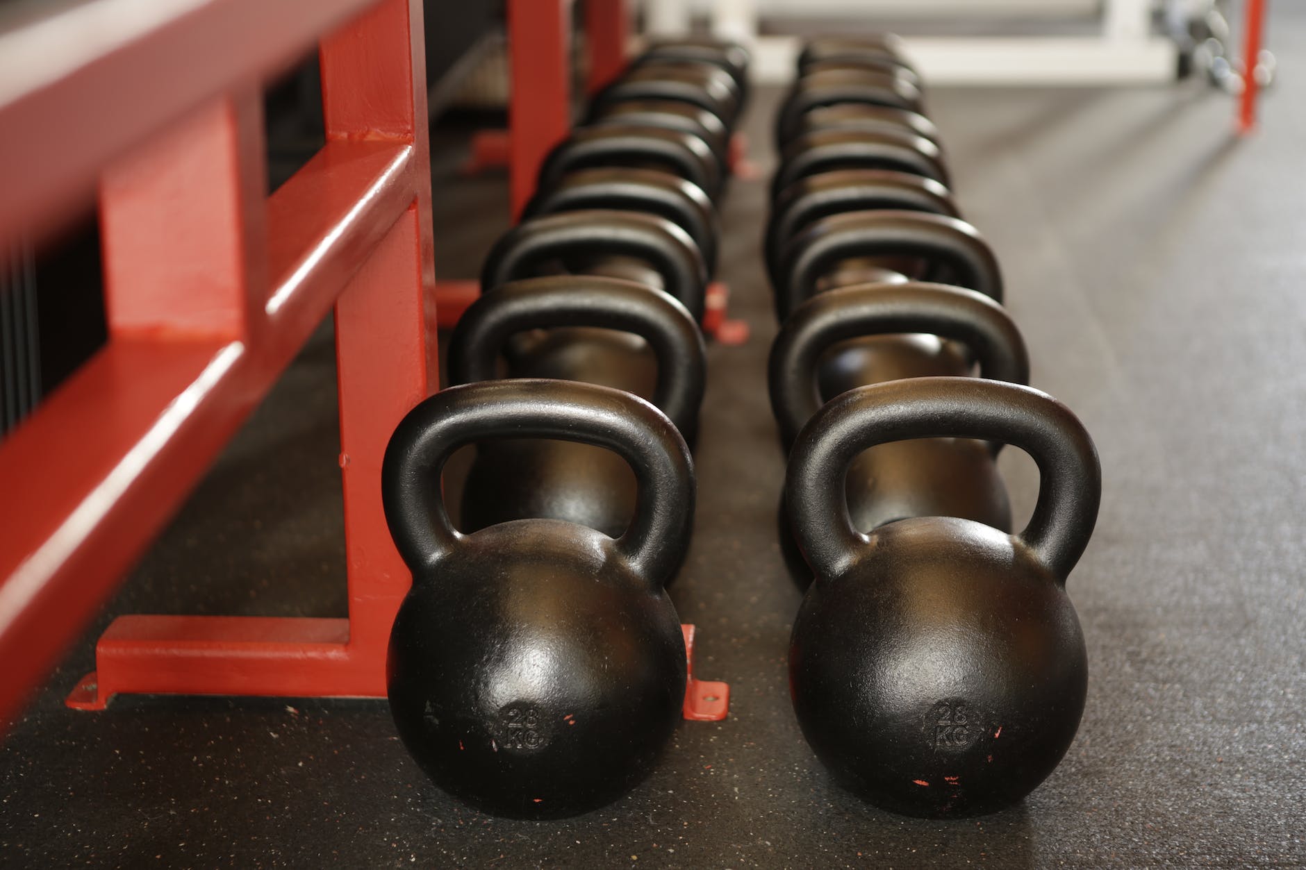 Black kettlebells highlighting gym business authority importance.